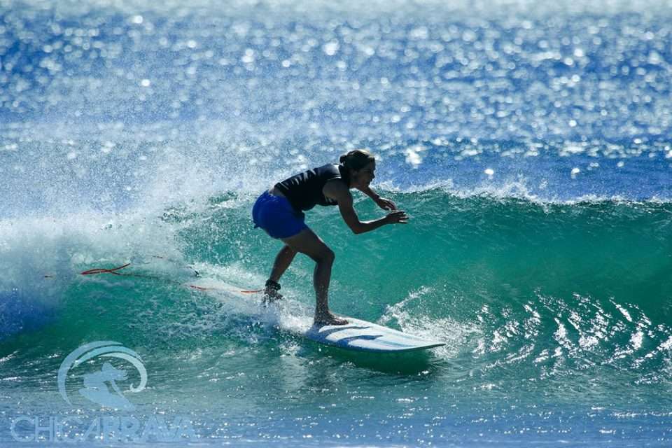 girl surfing the face of a wave in Nicaragua