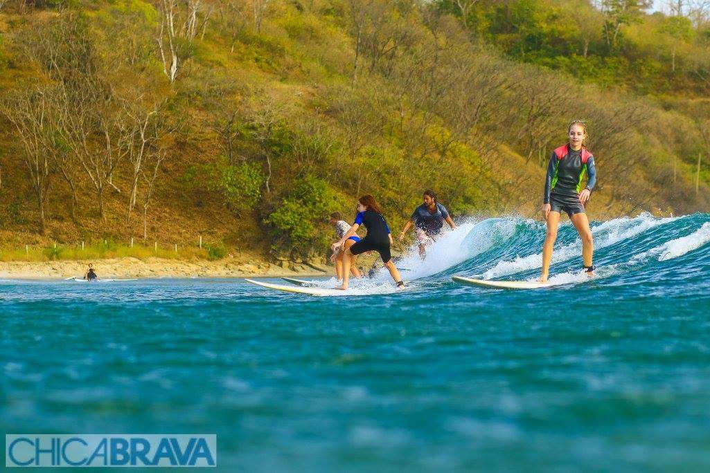 many women surfing the same wave at Nicaragua surf retreat