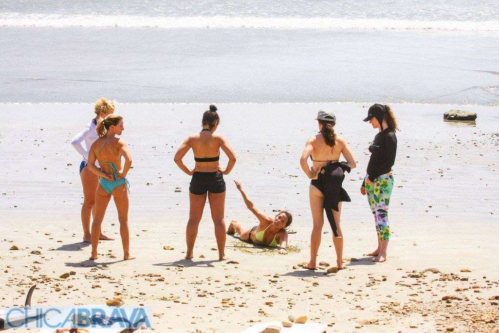 Women receiving surf instruction at a beach in Nicaragua